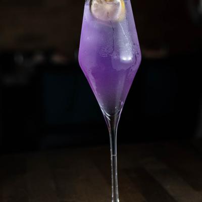 A glass of purple cocktail