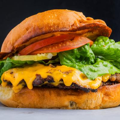 Factory Smash Burger with American cheese, lettuce, tomato and pickles.