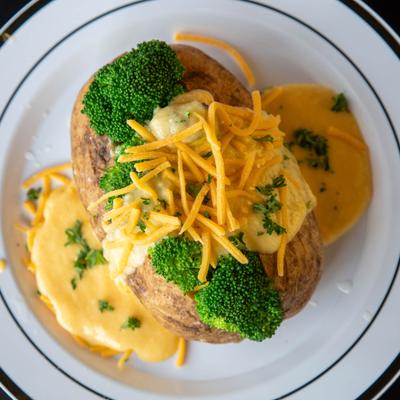 Baked potato stuffed with cheddar and broccoli.