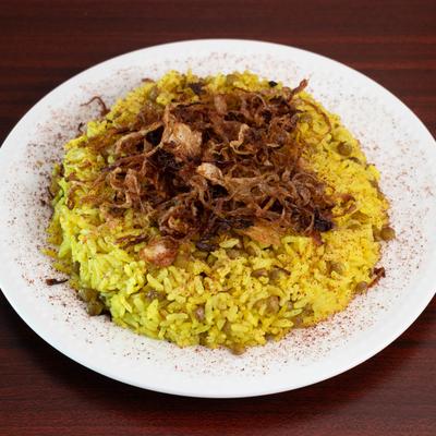 A blend of rice and lentils topped with seasoning and caramelized onions.
