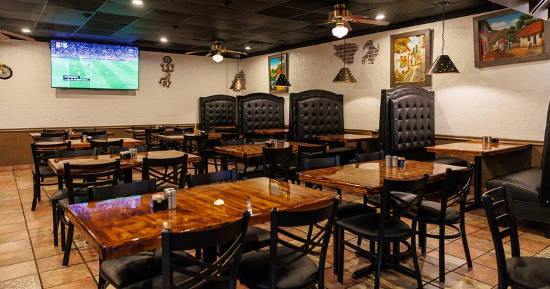 Interior dining area with upholstered dining booths and dining tables and chairs