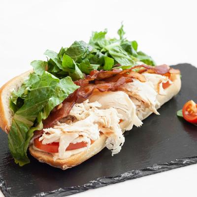 Roasted turkey breast sandwich, with tomato, bacon, and lettuce.