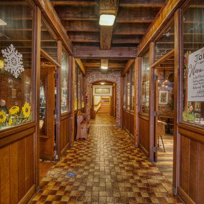 Restaurant's hallway with checkered tile pattern floor and wood paneling.