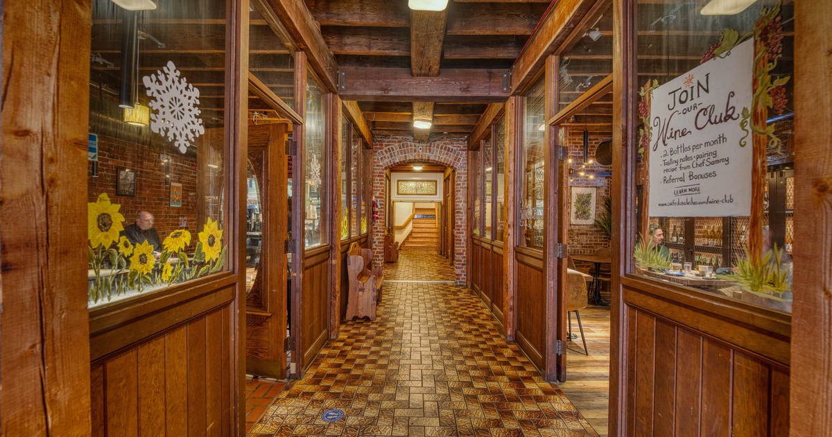 Restaurant's hallway with checkered tile pattern floor and wood paneling