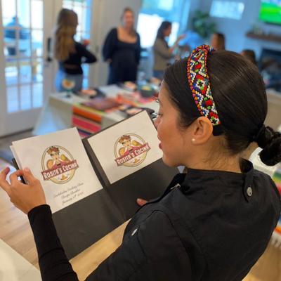 Chef holding a recipe booklet.