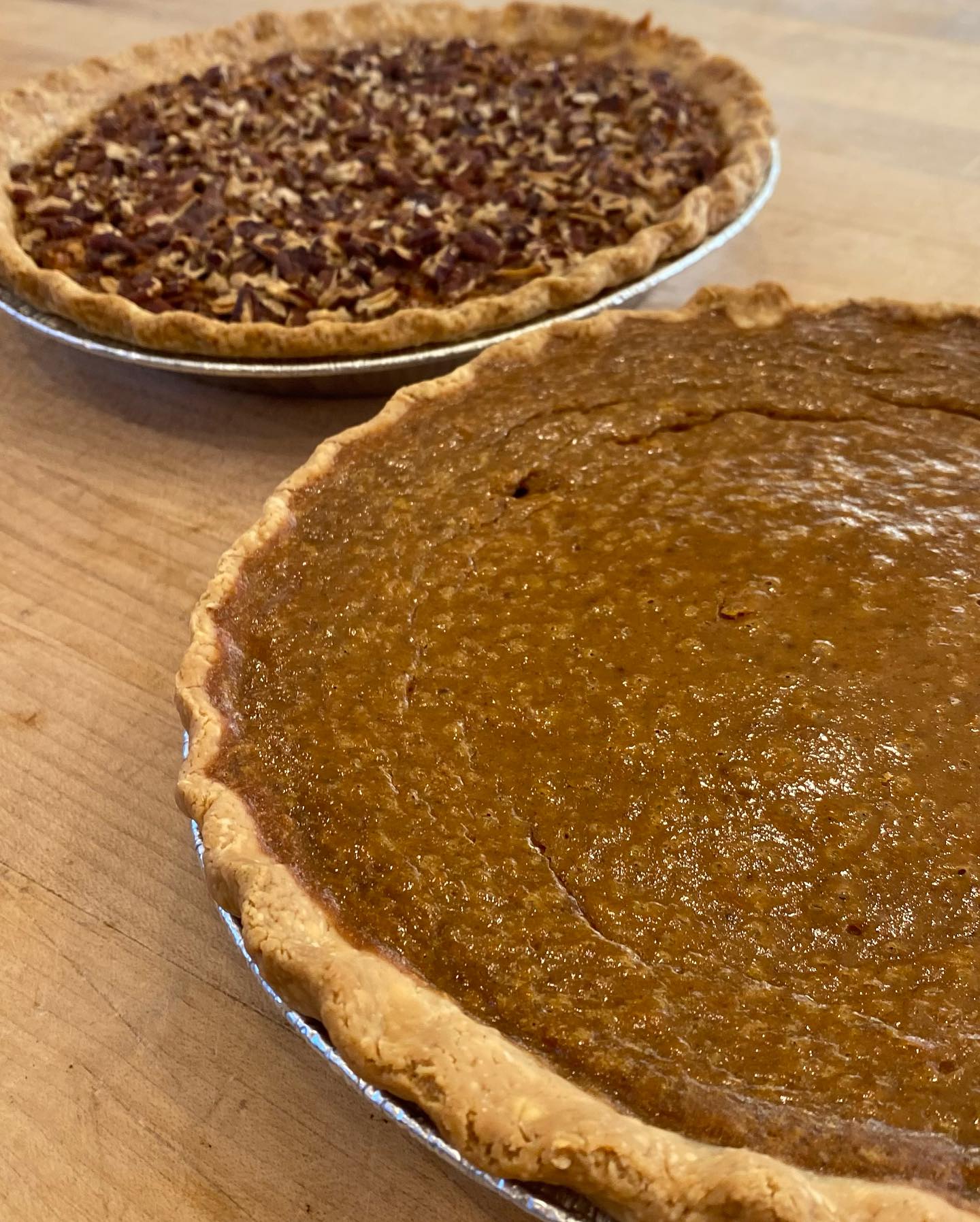 Pumpkin and Pecan Pies adjacent to each other.