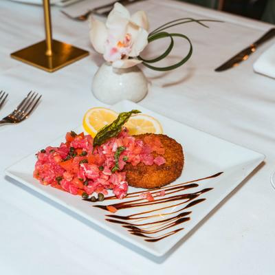Tuna tartar with chopped tomatoes and risotto cake.