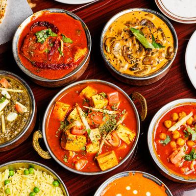 Overhead view of various Indian curries and basmati rice.