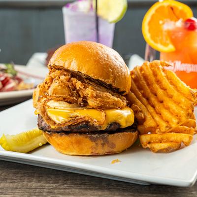 Cheeseburger with crispy onions and waffle fries.