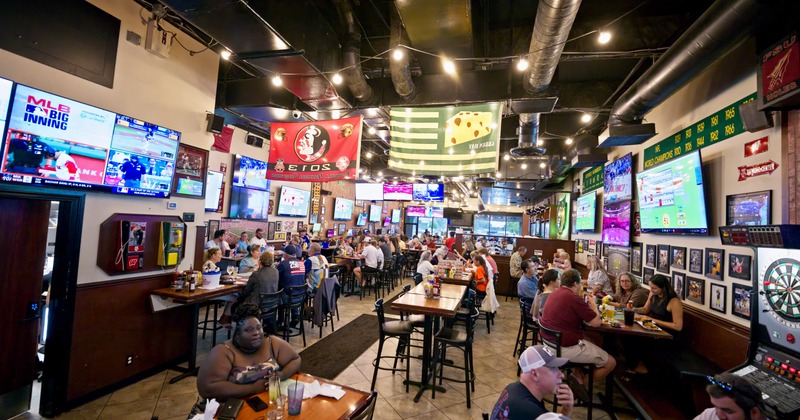 Interior, large dining area with multiple TV screens