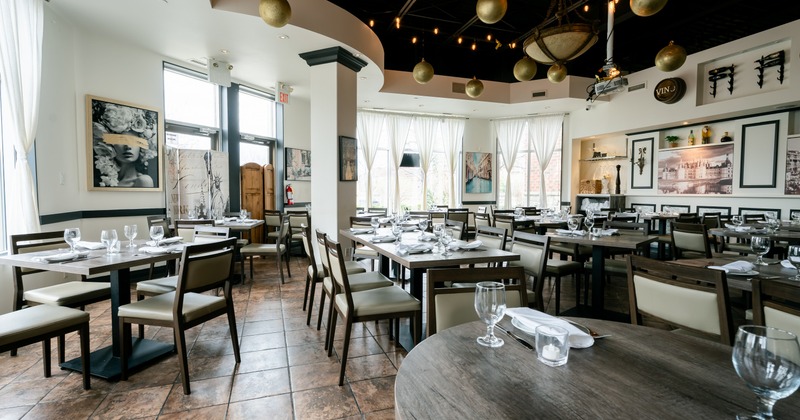 Interior, dining space with art on the walls, curtains on the windows