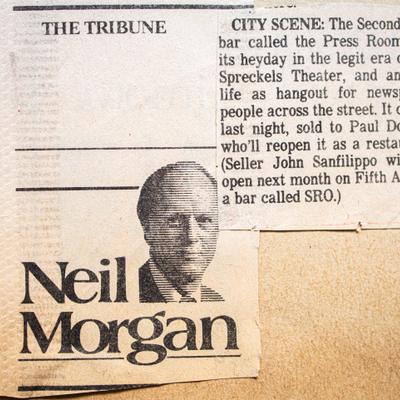 An old newspaper clipping featuring a partially visible article and a headshot of Neil Morgan