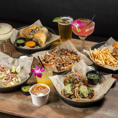 Assorted dishes and drinks on a wooden tables.