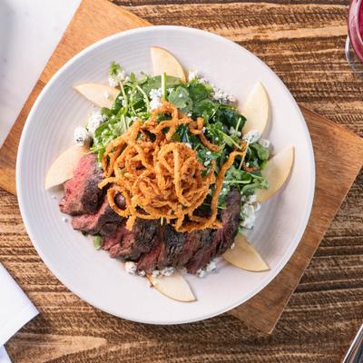Hanger steak, with arugula, spinach, blue cheese, apples, and crispy onions.