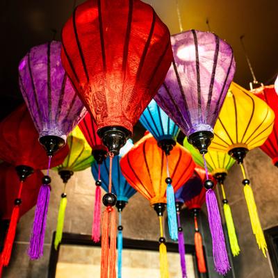 Multi colored hanging lanterns adorn the ceiling inside