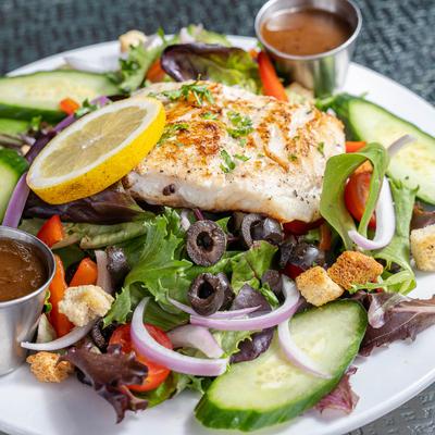 House Salad, with greens, tomato, cucumber, almonds, croutons, and vinaigrette.