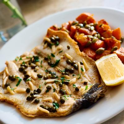 Fish fillet with capers, almonds, and roasted butternut squash.