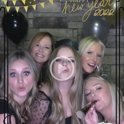 A group of cheerful people posing for a shot inside.