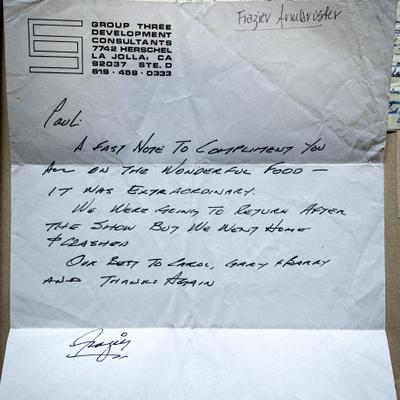 A handwritten note with a signature, complimenting the food