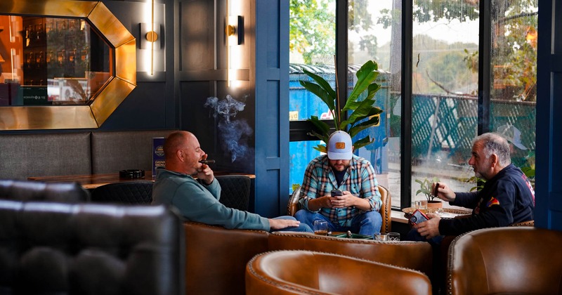 Guest seating in armchairs, smoking the cigare