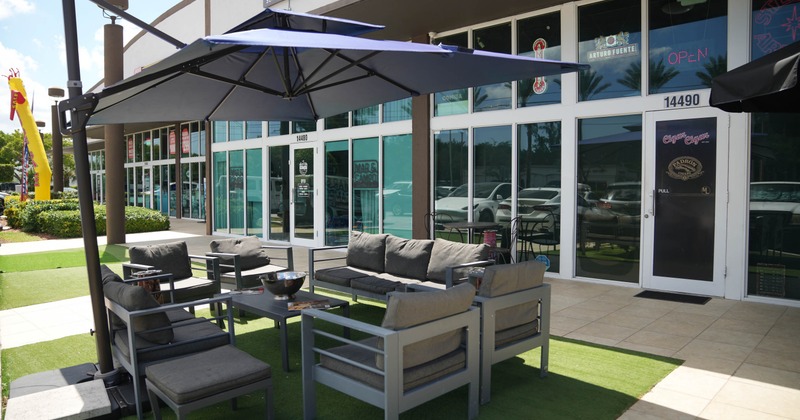 Outdoor patio with gray lounge seating and umbrellas