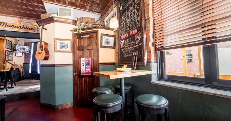 Interior, table and bar stools next to the window