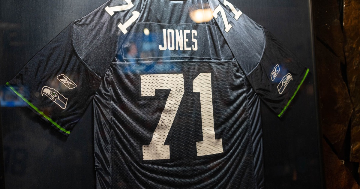 Football jersey number 71 displayed on a wall