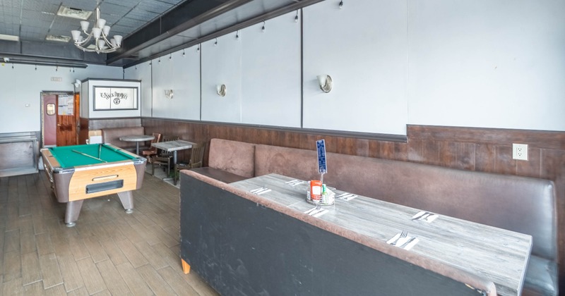 Interior with dining table and pool table.
