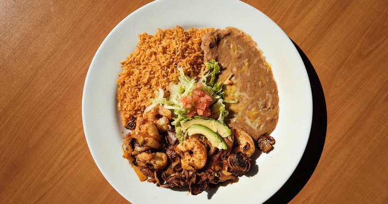 Grilled shrimp, mushrooms, pico de gallo, lettuce, avocado, rice, and beans