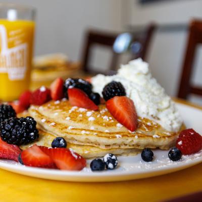Pancakes with berries and whipped cream.
