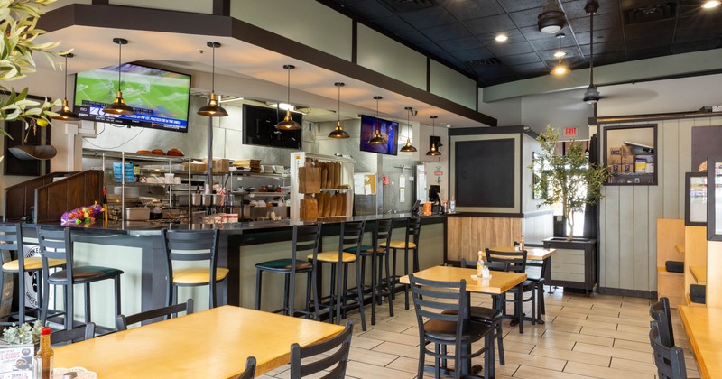 Interior seating area with chairs, tables and a bar