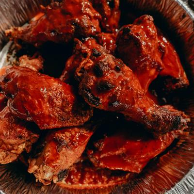 Buffalo wings covered in hot sauce.