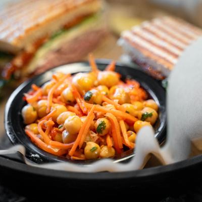 Side carrot and chickpea salad on a dark plate.
