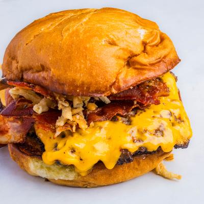 Double OG Burger with cheddar, caramelized onions and bacon.