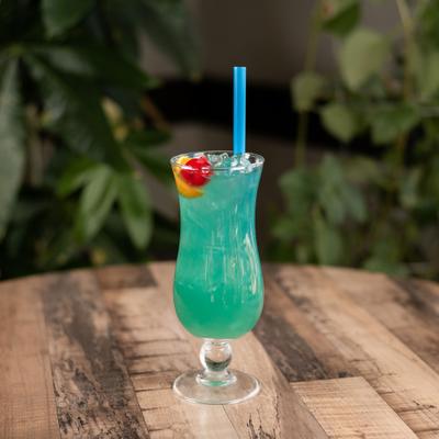 Cajun Punch served in hurricane glass with cherry and citrus garnishes.