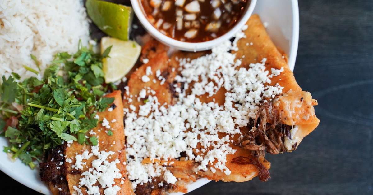 Tacos topped with white cotija cheese