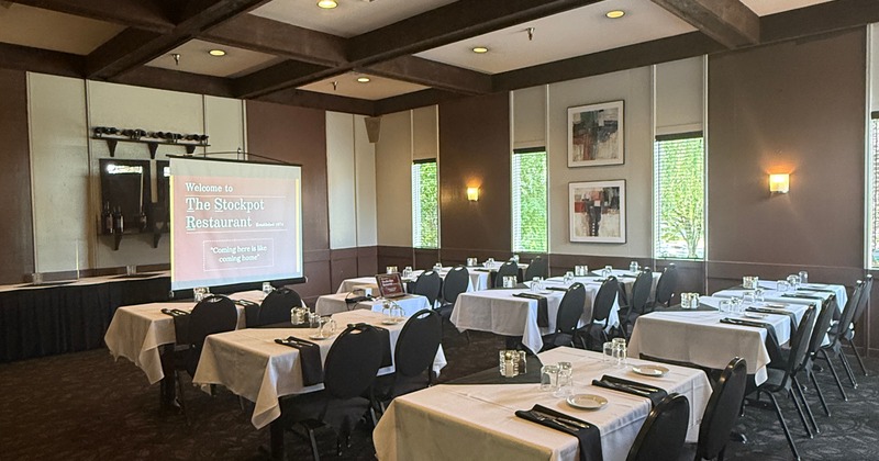 Interior, tables set for guests in dining area