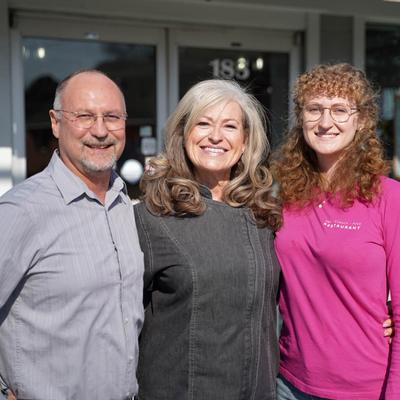 The owners' family smiling at the camera.