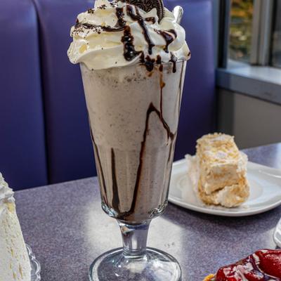 Oreo milkshake topped with whipped cream.