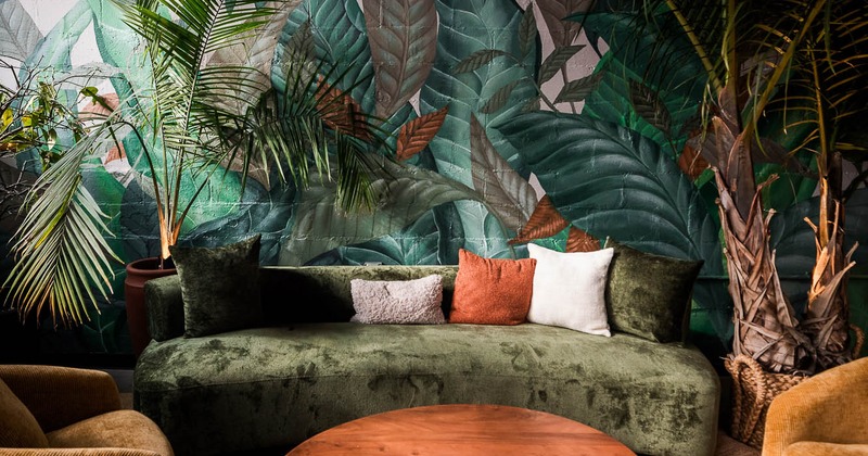 Interior, lounge area, sofas and armchairs with table, lavish plant decoration