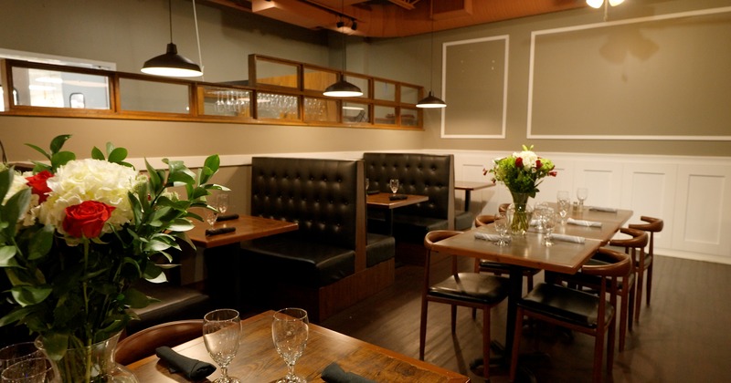 Interior, dining space decorated with fresh cut flowers