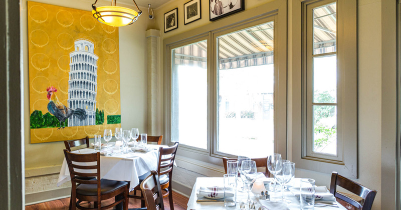 Interior, couple of tables by the wall with a hanged painting