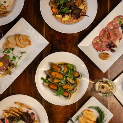 Assorted food dishes spread on table, top view.