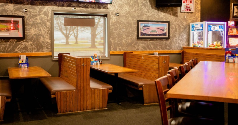 Interior, wooden benches and tables, framed pictures on the wall