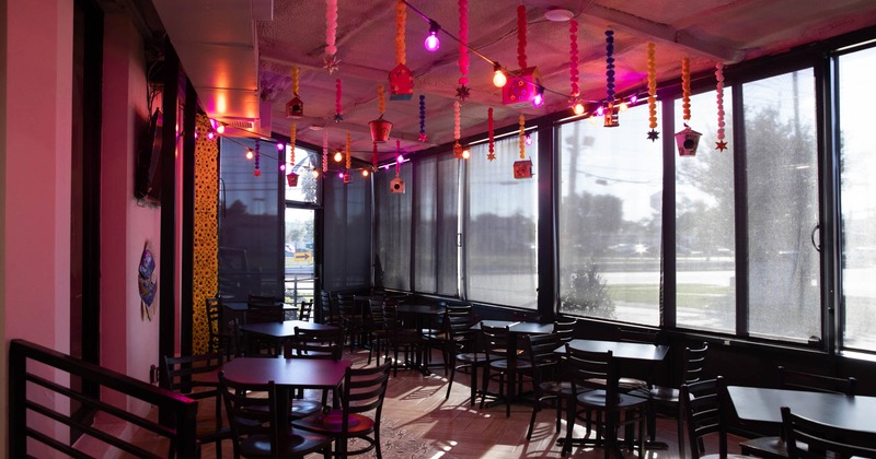 Interior, tables, chairs, windows, hanging decorations, lighting, glass doors