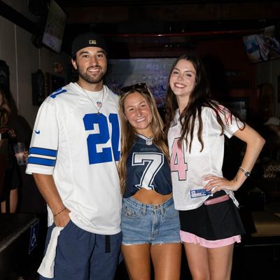 Interior, three people posing for a photo.