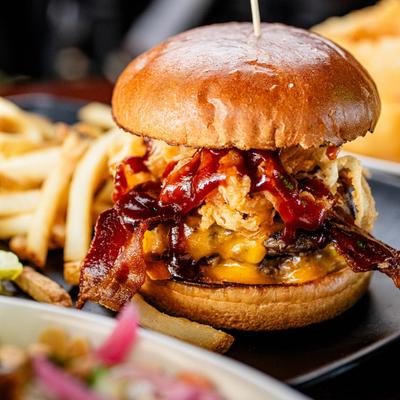 BBQ bacon cheeseburger with cheddar, crispy onion straws, and fries.