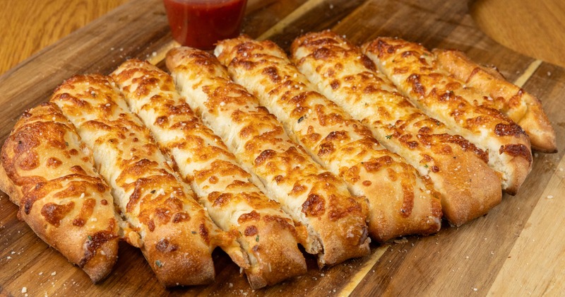 Cheesy Breadsticks served with marinara sauce on the side