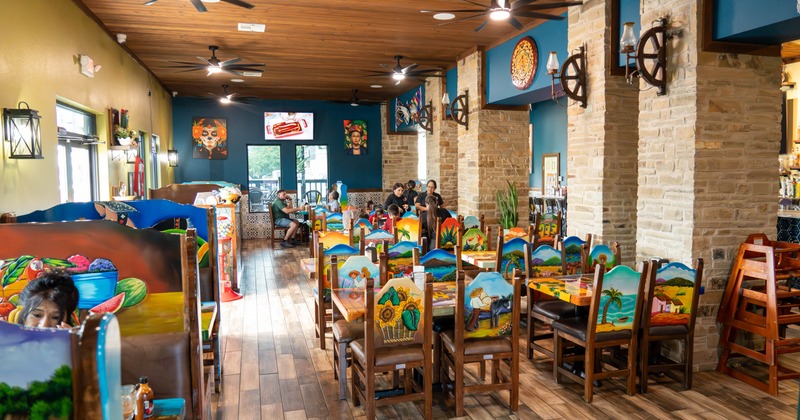 Colorful restaurant interior with hand-painted furniture and wooden decor