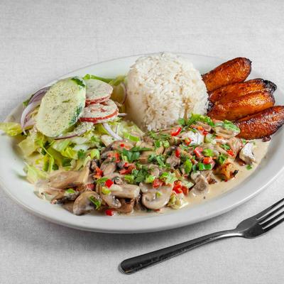 Grilled chicken breast, mushroom sauce, served with rice, salad and plantains.
